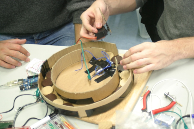 Modeling a design concept out of cardboard to ensure the electronics fit into the enclosure